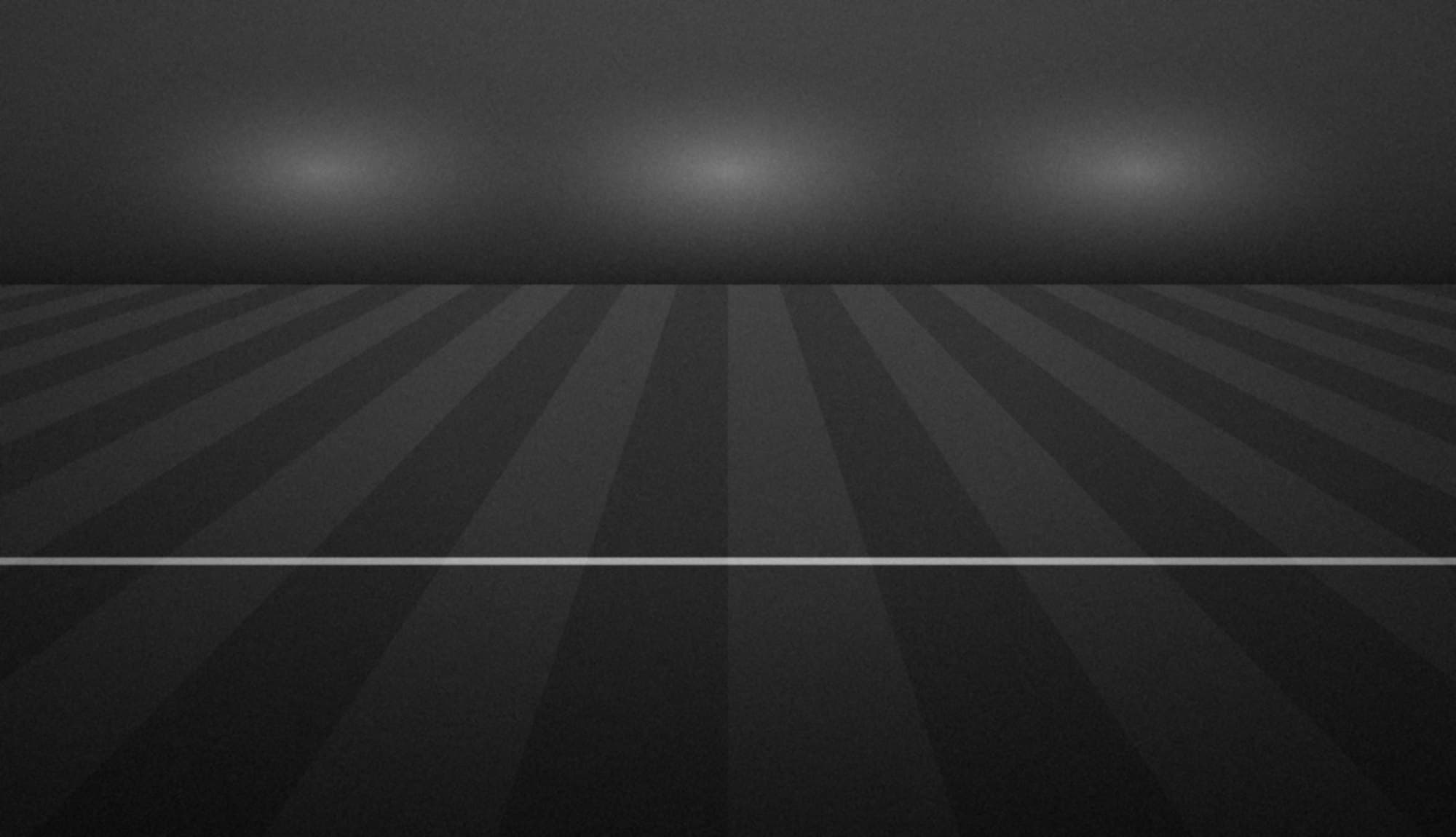 Wide view of a football pitch under warm light